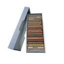 A small open cassette tape storage box with multiple cassette tapes in their original cases, lying in an organized fashion.